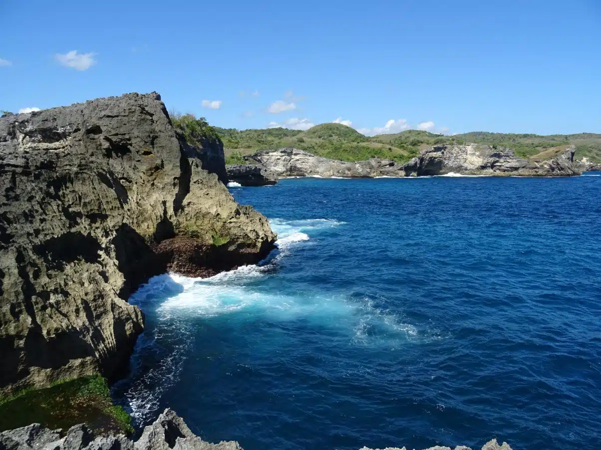 Perfect blue sea crashing into cliffs