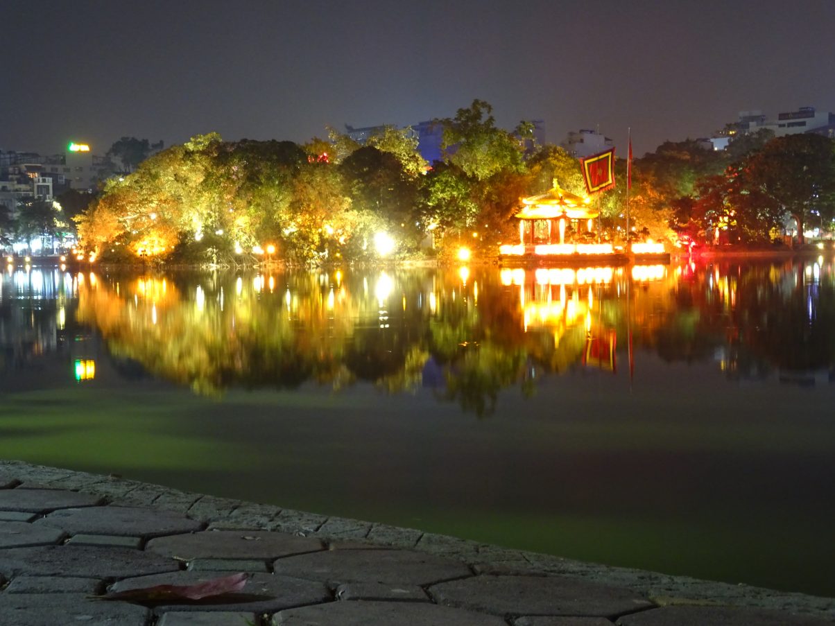 Hoan Kiem lake at night brightly lit with lights, Vietnam