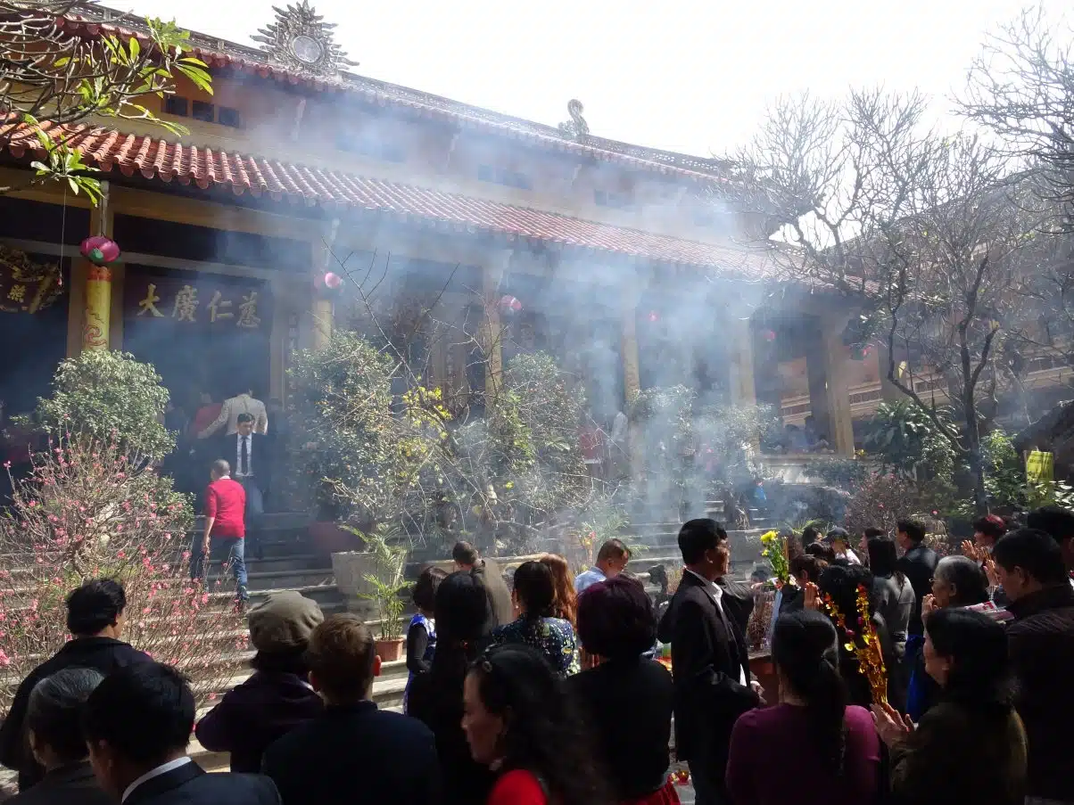 Vietnamese temple during Tet with many worshippers 