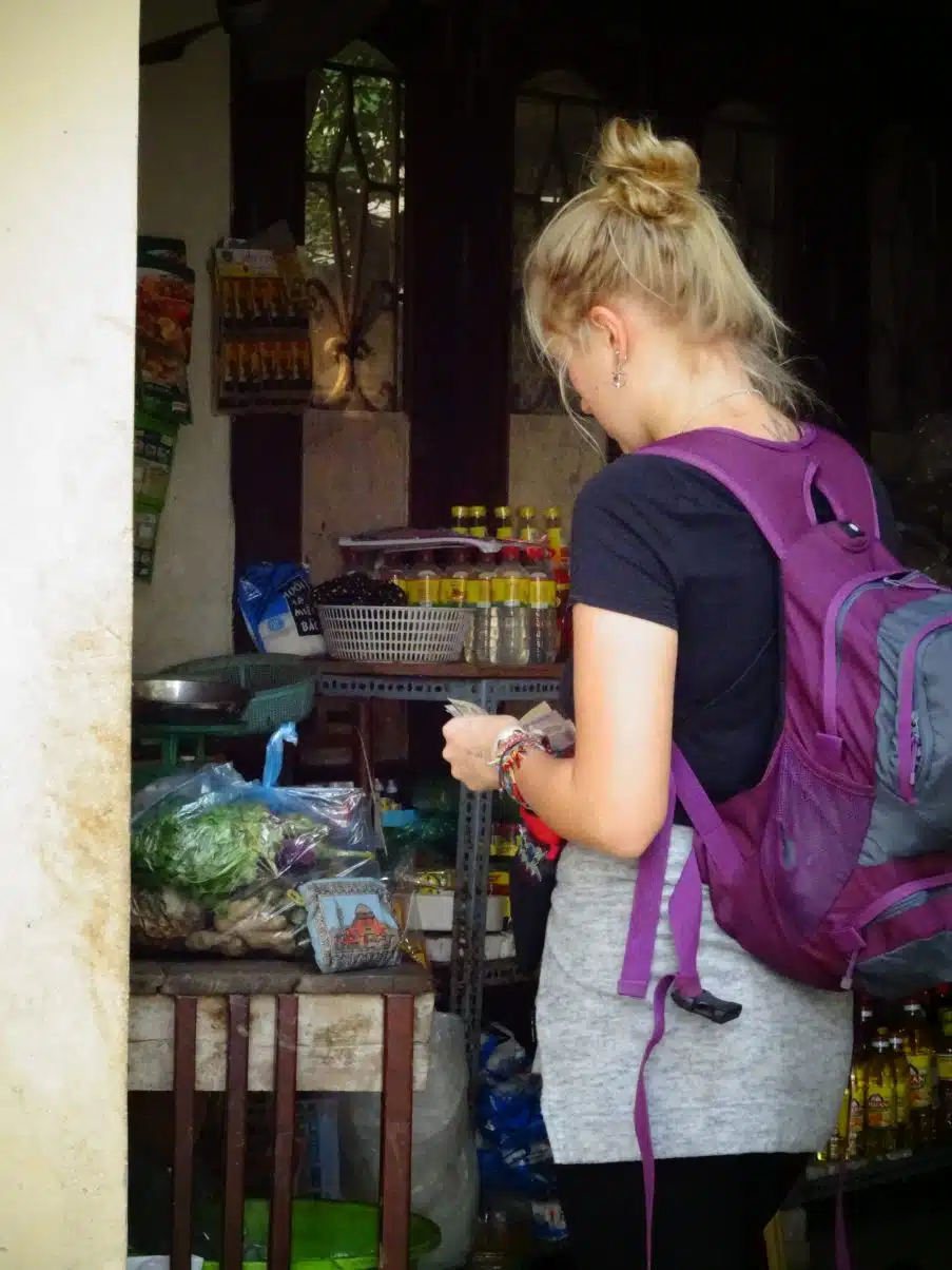 Girl buying from market in Hanoi, Vietnam