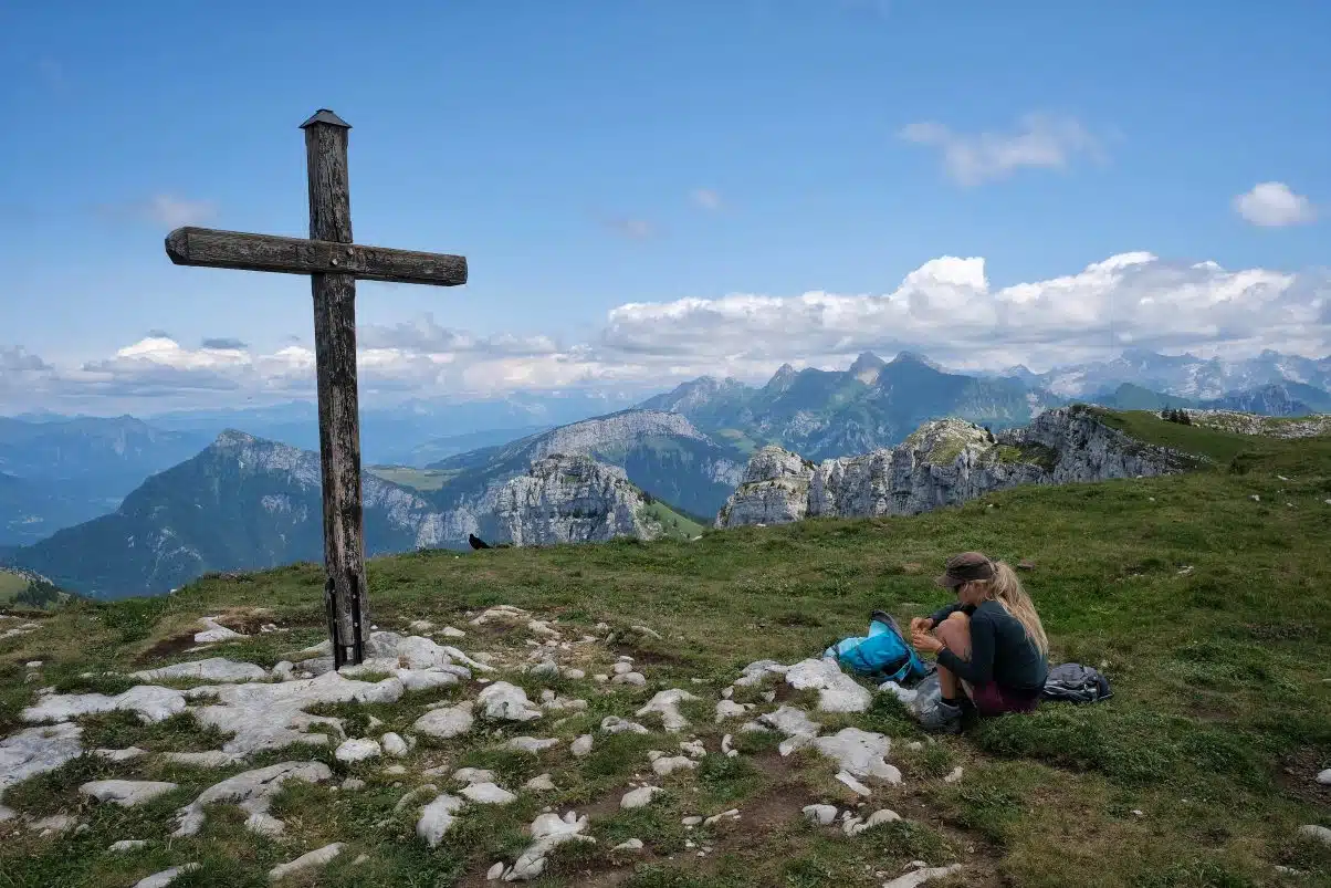 Girl sitting on top of mountain 