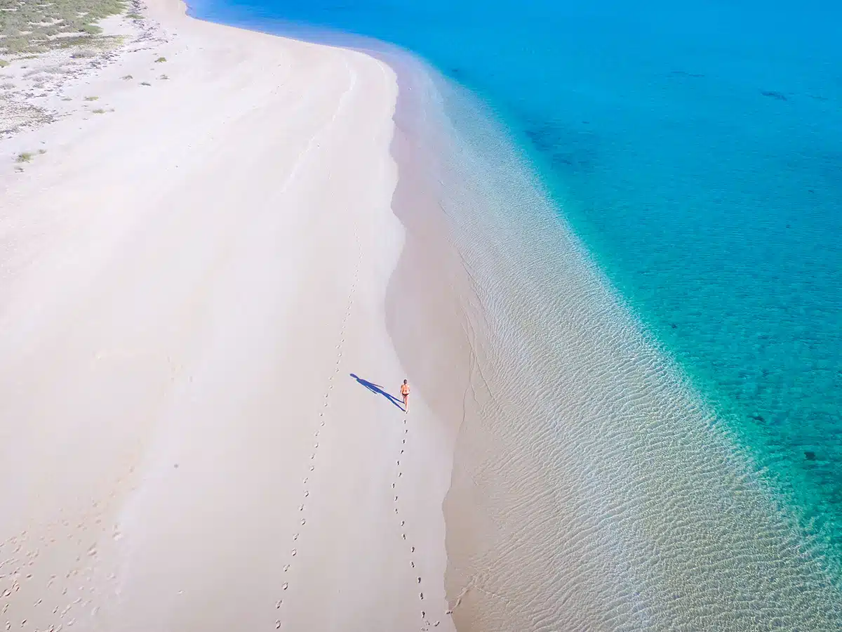 A drone shot of a women on a beach