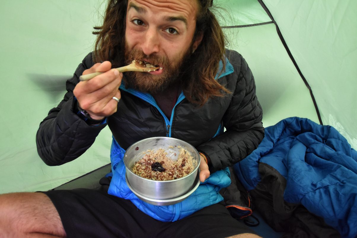 The Honest Truth About Travelling as a Vegan in France 4 Man eating porridge in tent in France