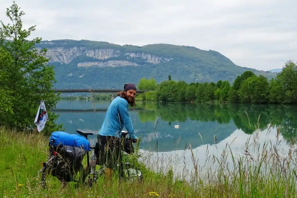 Man on bike in front of lake