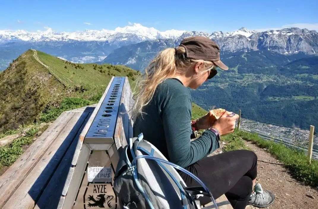 Girl on mountain eating vegan hiking food