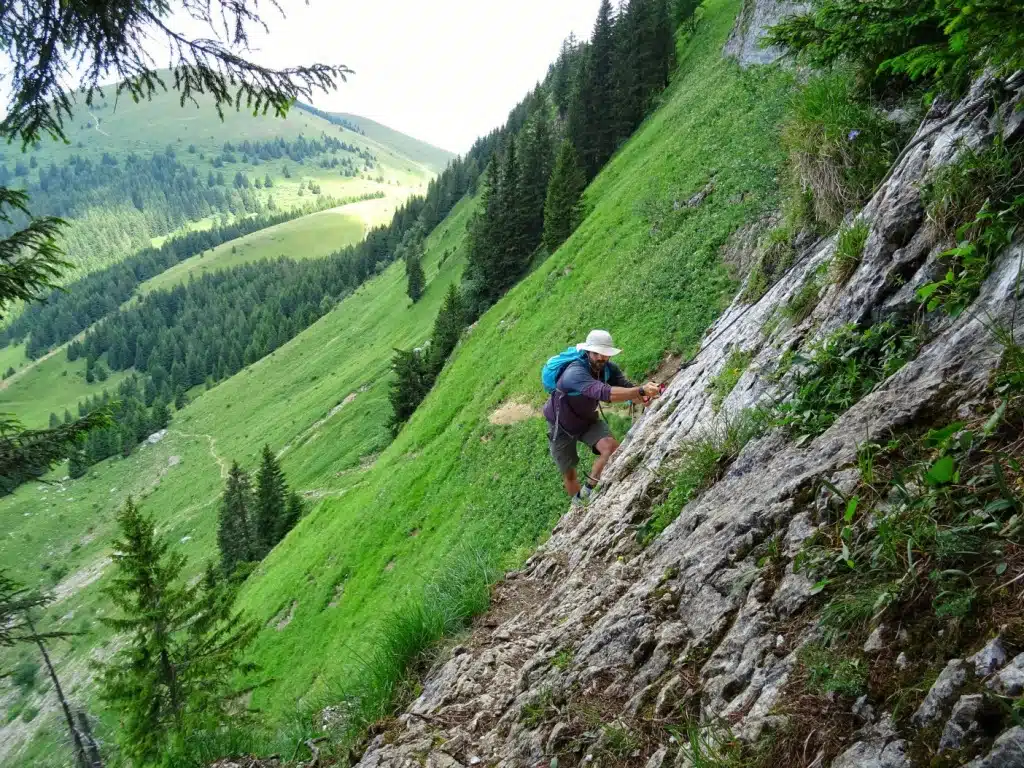 Man scrambling up mountain 