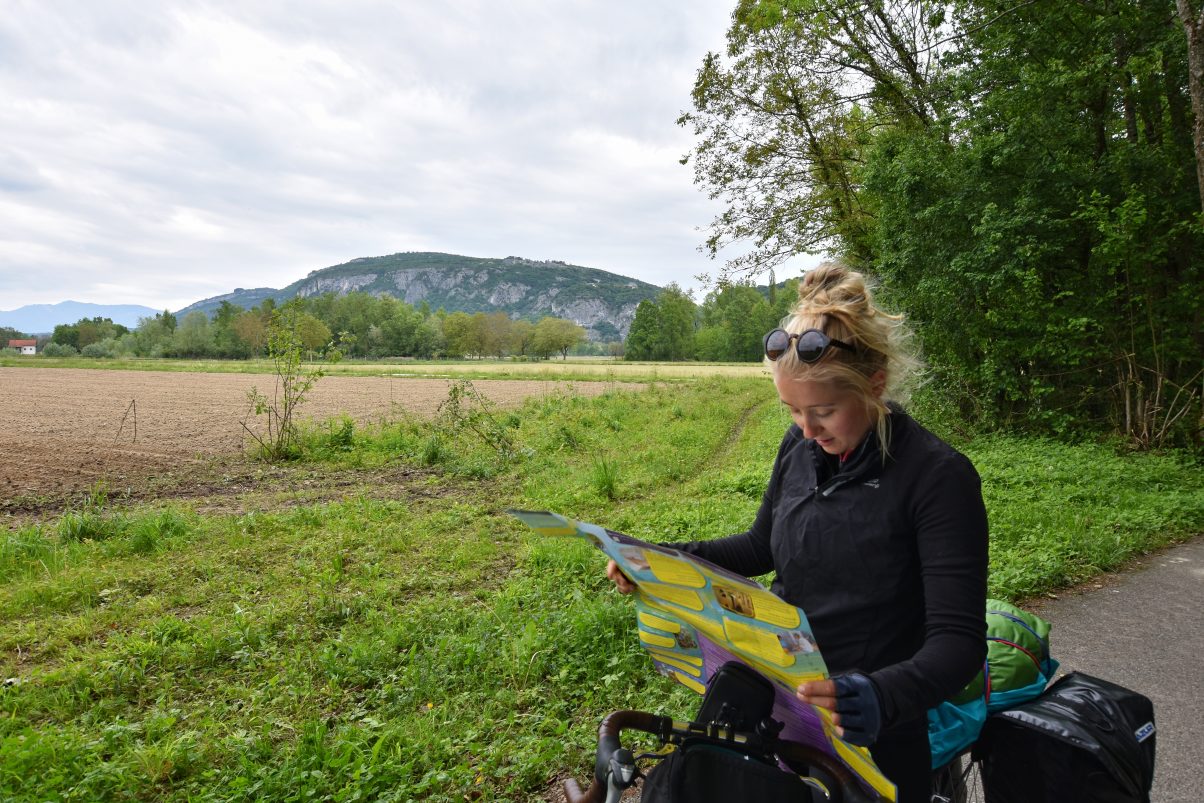 Female cyclist looking at map