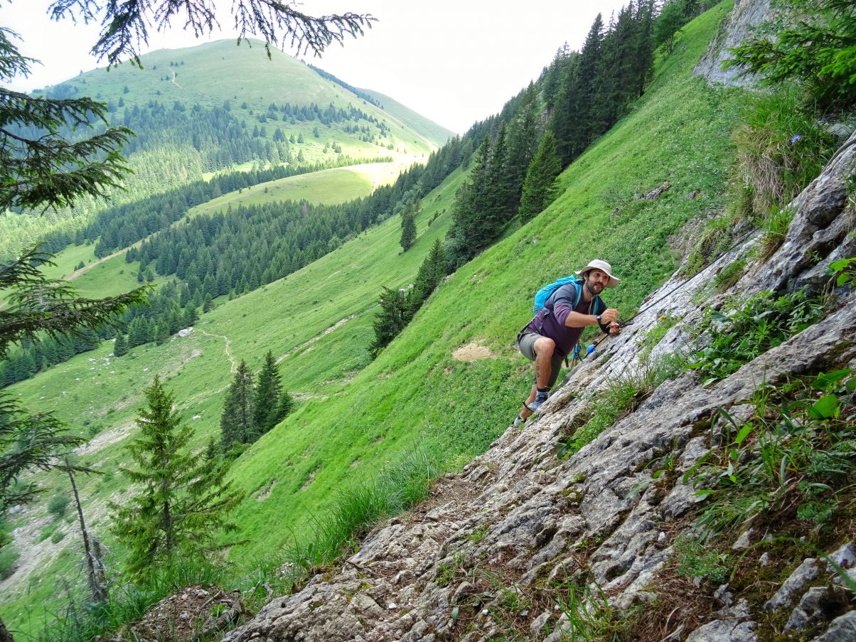 Man scrambling up mountain