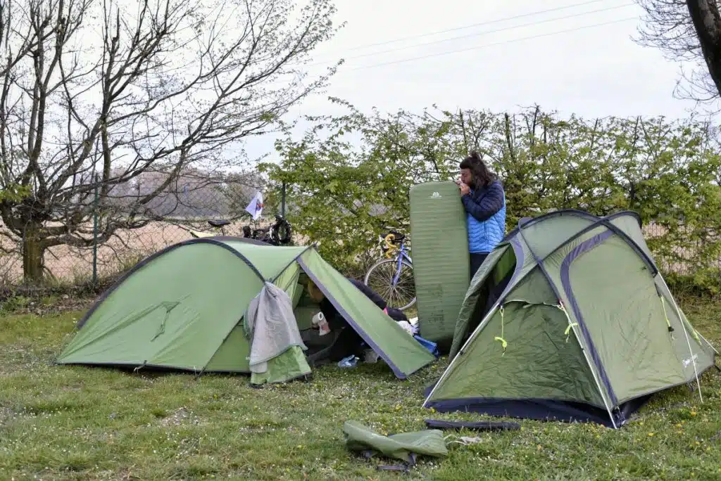 The Best Camping Sleeping Pads and Mats for 2025 3 Man pitching tent in the outdoors