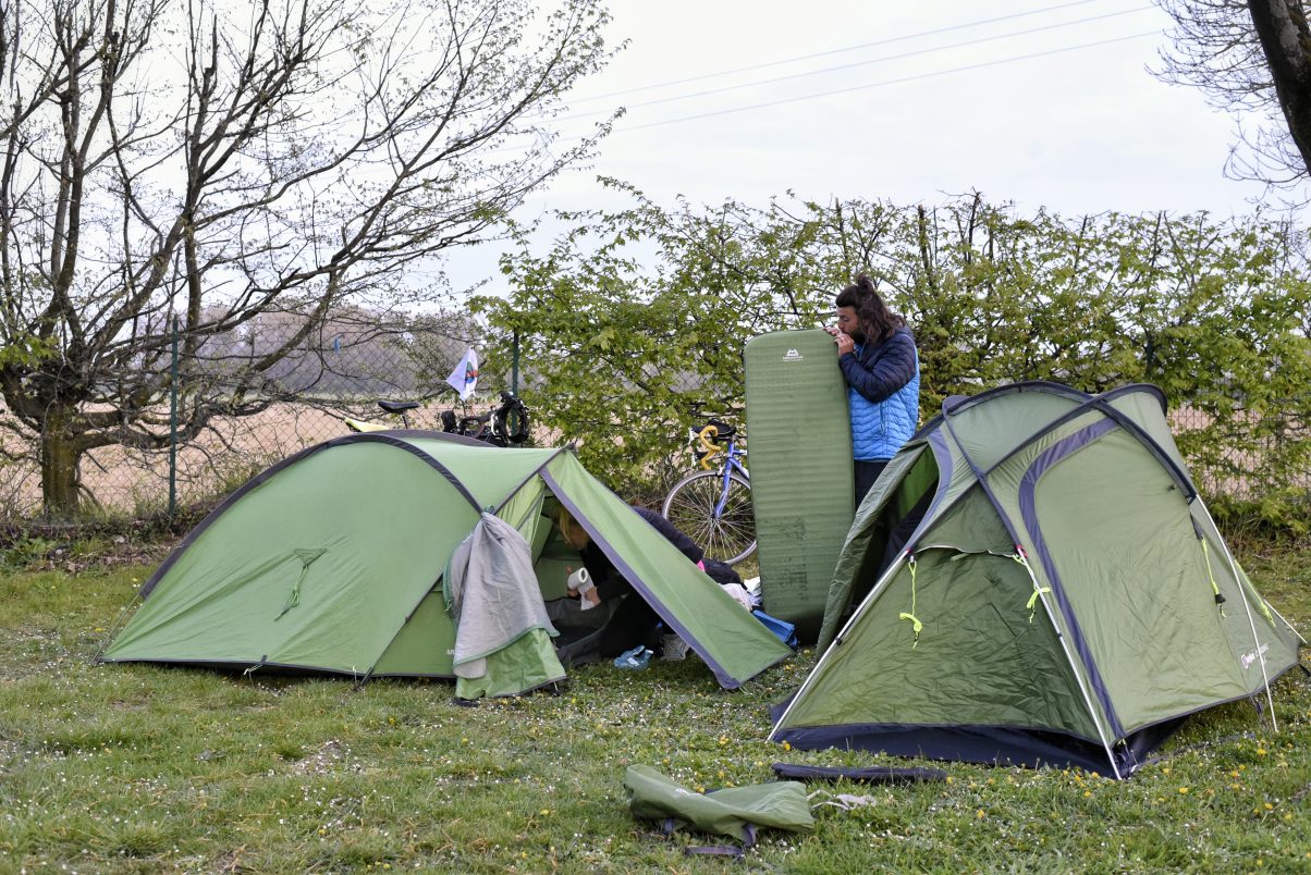 Man pitching tent in the outdoors 