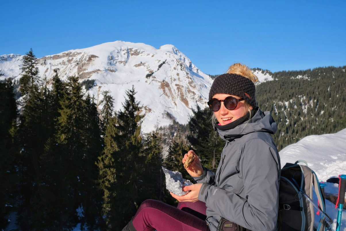 Girl eating vegan hiking food in winter