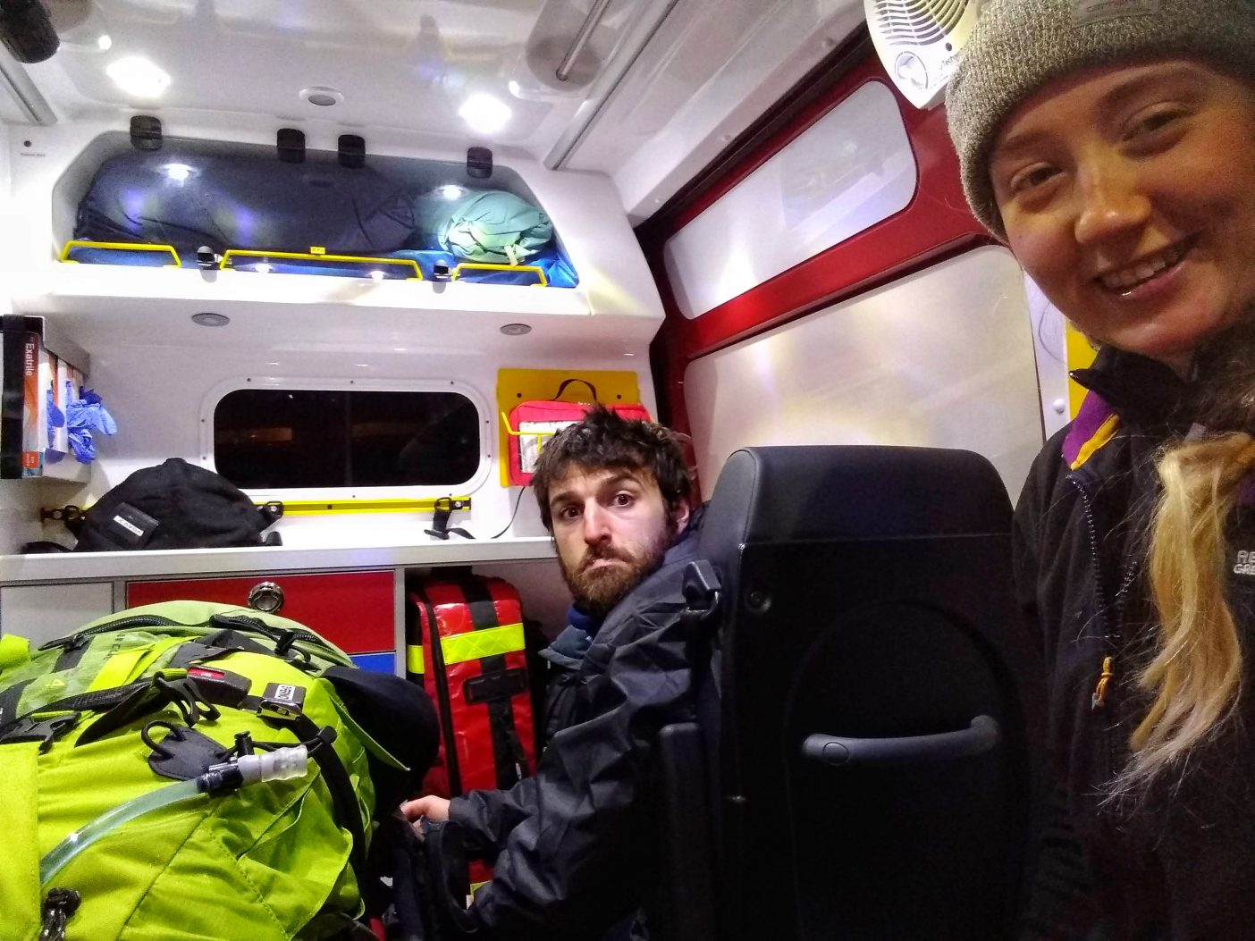 Two hikers in mountain rescue ambulance