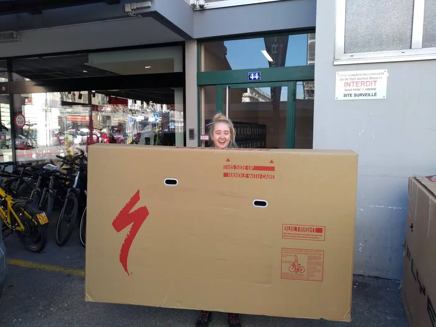 Girl carrying big bike box