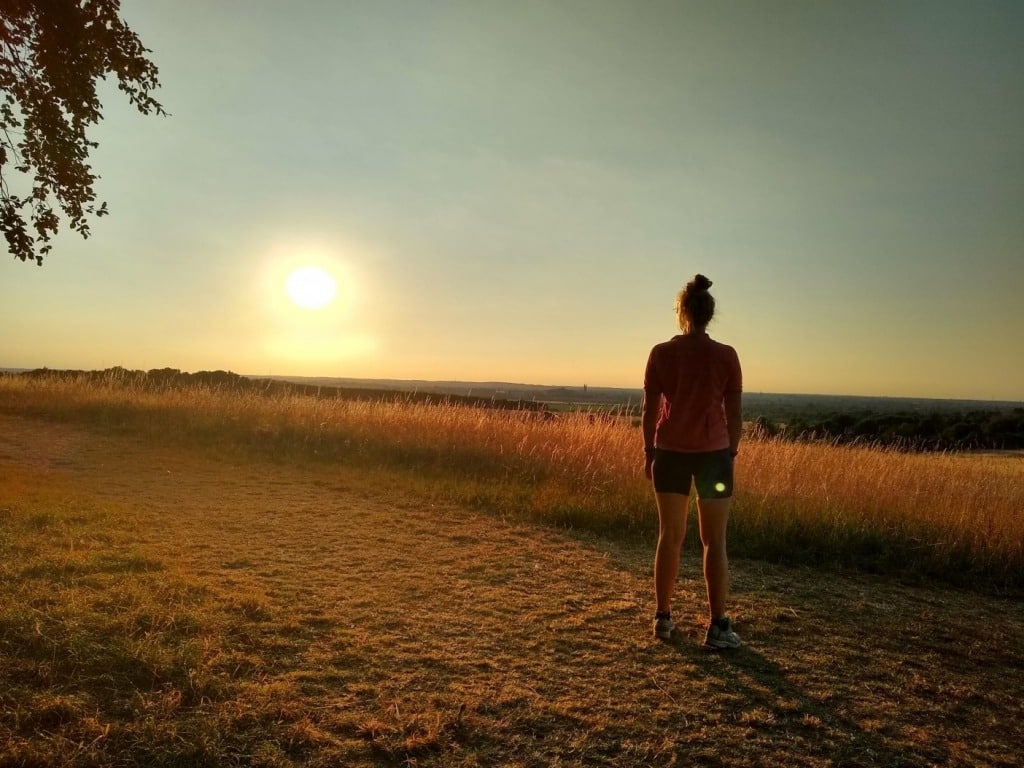 Girl trail running in sunshine