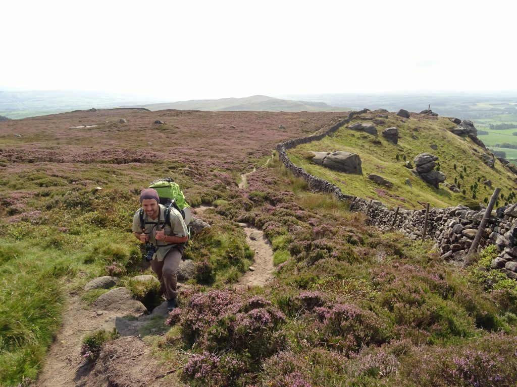 Zero waste hiking man on hill