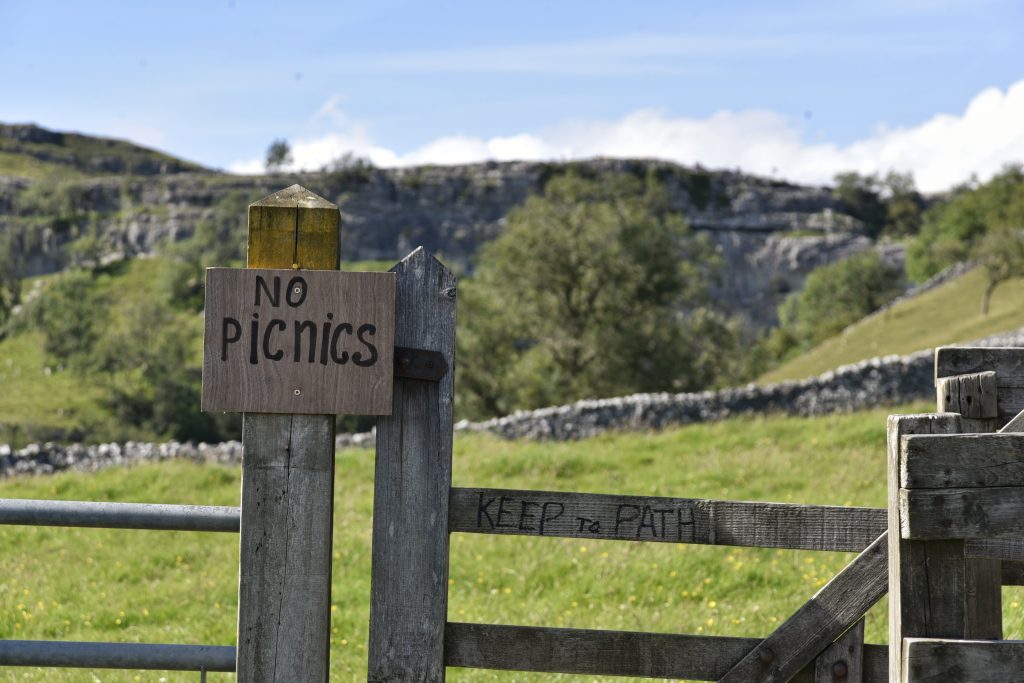 Signs promoting leave no trace hiking in outdoors