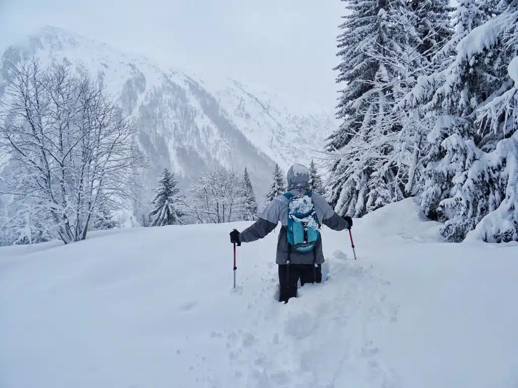 Man hiking in the snowy mountains, French Alps