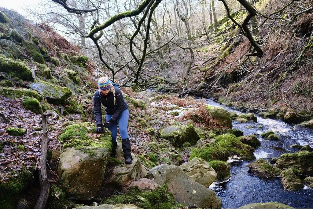 Girl stepping over rocks in gore-tex lined boots