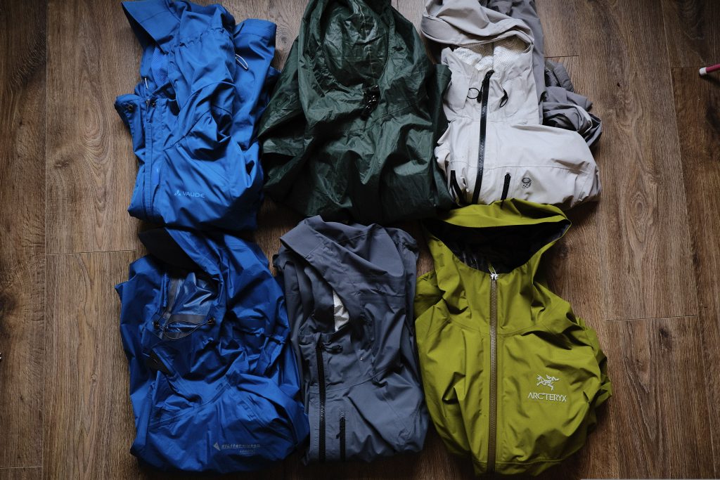 A selection of rain jackets on the floor