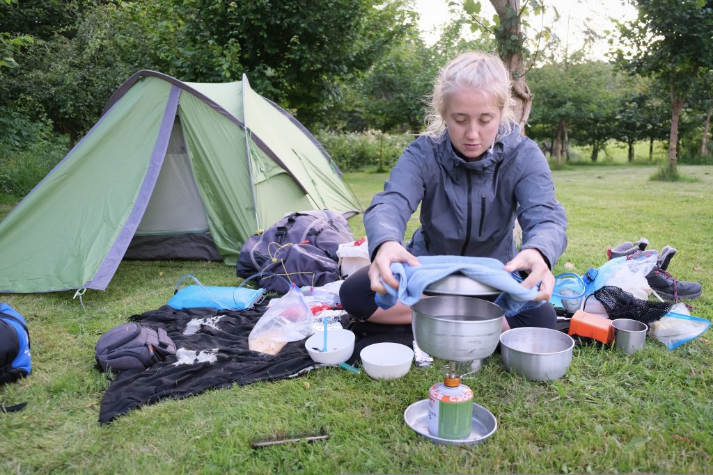 Girl cooking a vegan backpacking meal