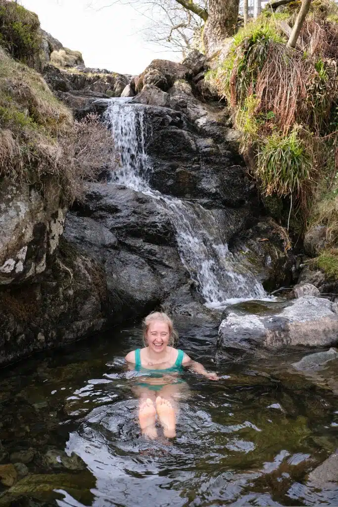 Girl wild swimming in the lake district