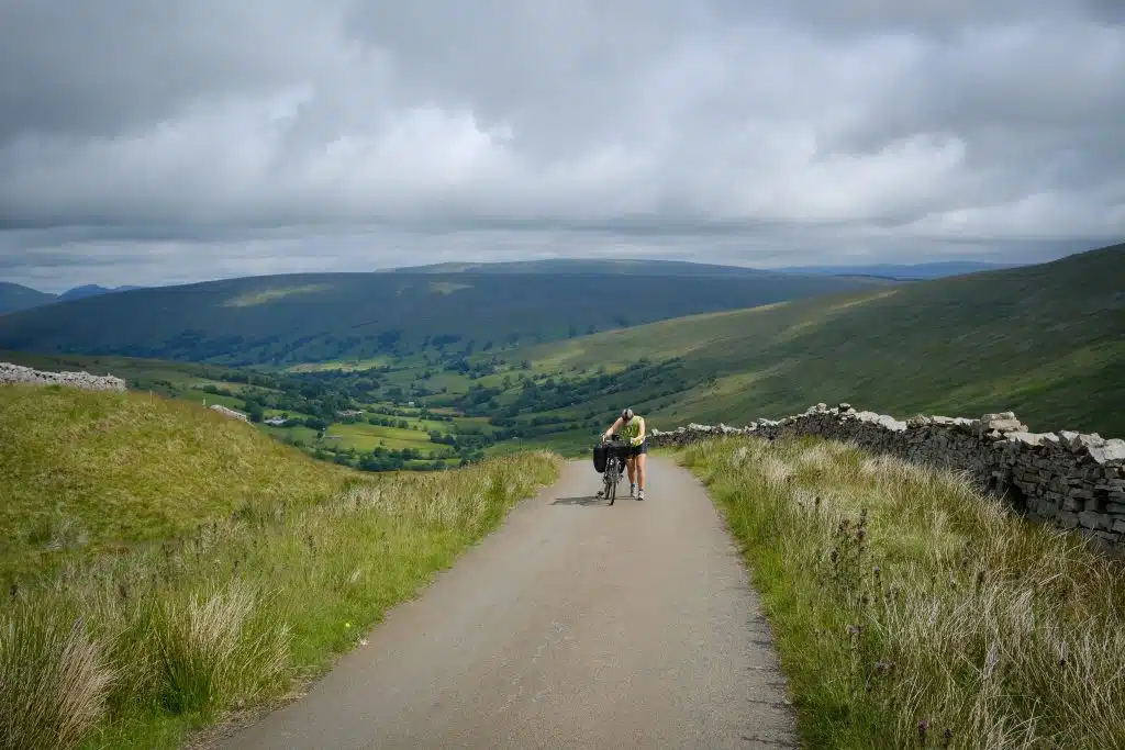 Female cyclist going up hill