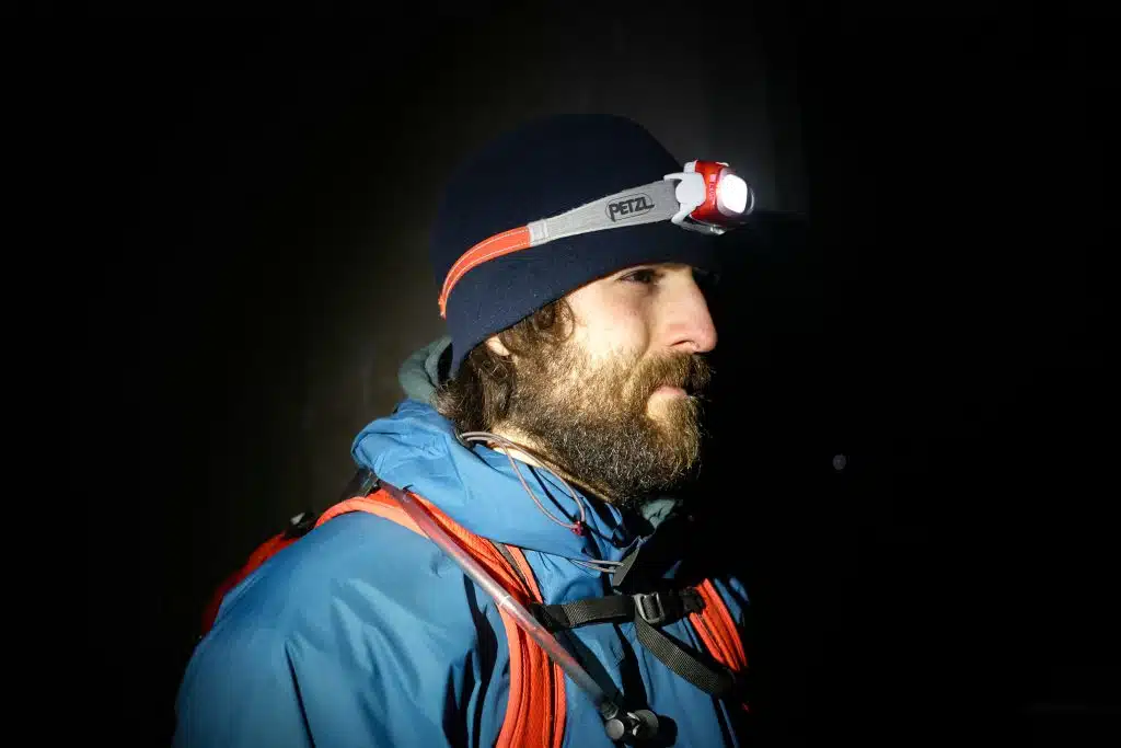 Man wearing swift rl trail running headtorch