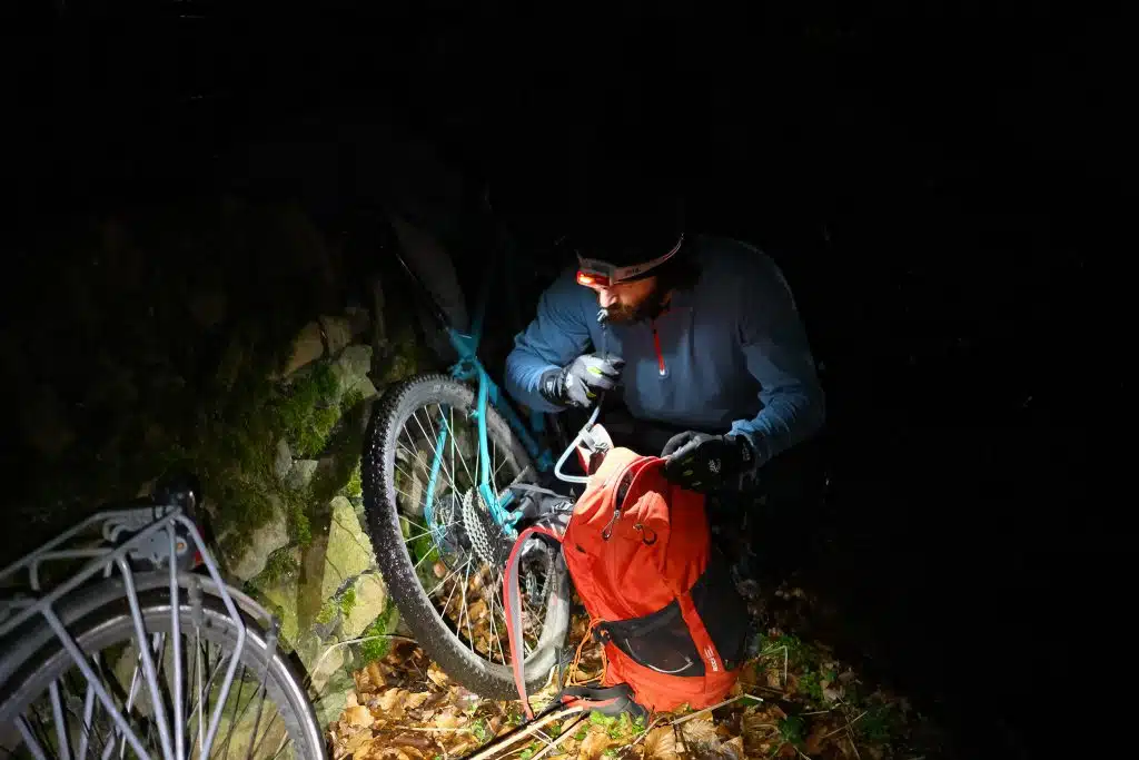 Cyclist using Petzl reactive lighting head torch