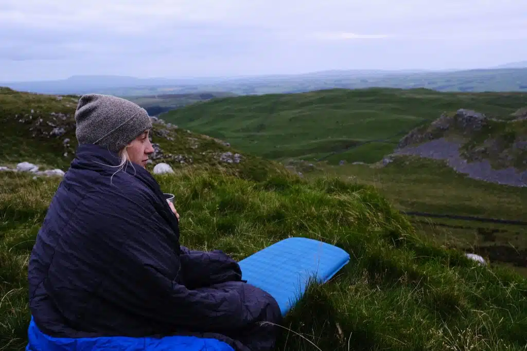 Girl camping with synthetic down sleeping bag