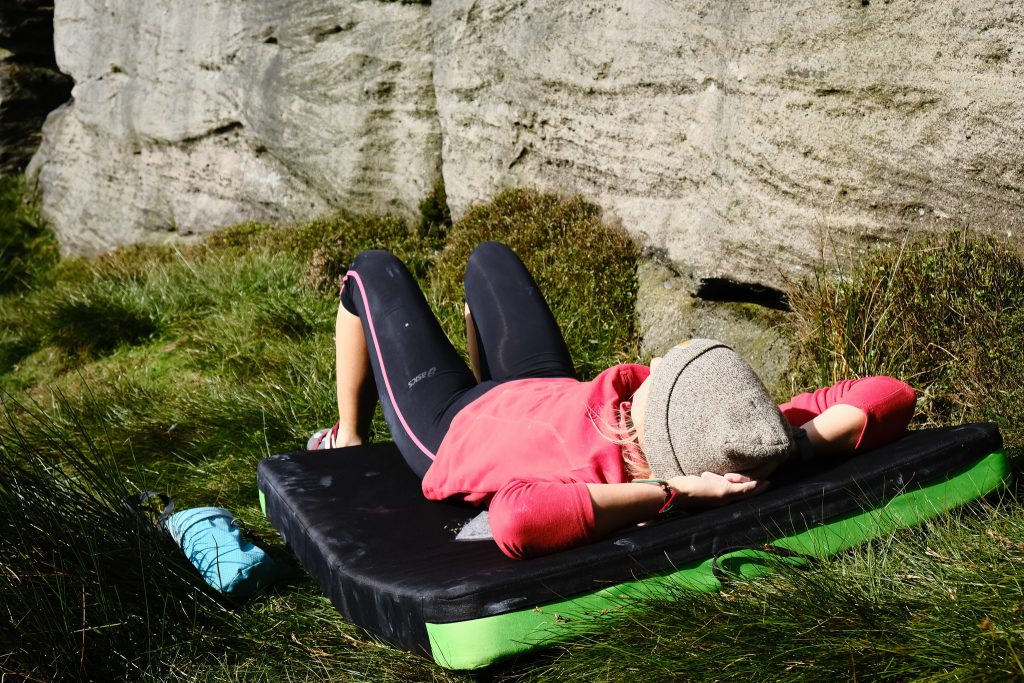 Climber lying on climbing pad